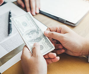 Short stack of cash in employee's hand